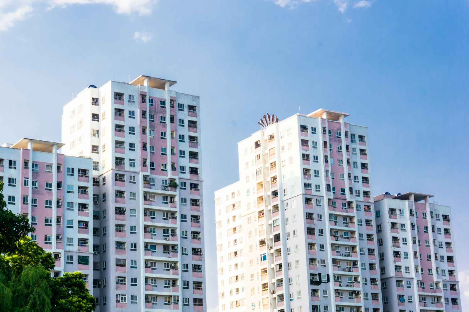 white concrete high rise building with condominium insurance under blue sky during daytime